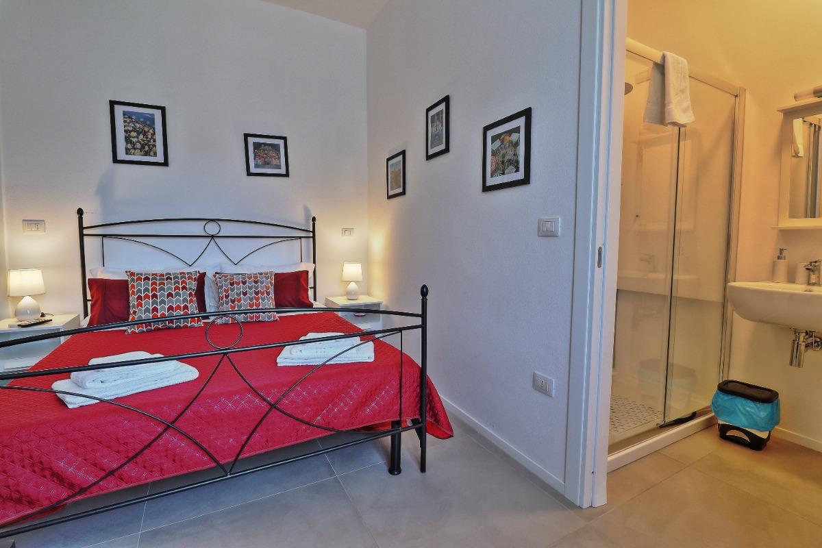 La camera, con bagno privato, è attrezzata con letto matrimoniale, aria condizionata, poggia valige, scrivania, TV, asciugacapelli.