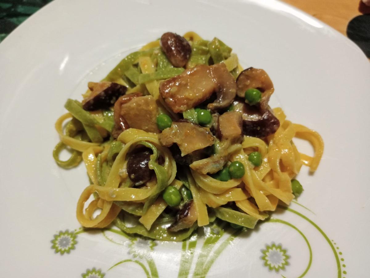 Straw and hay tagliatelle with mushrooms, peas and gorgonzola cheese