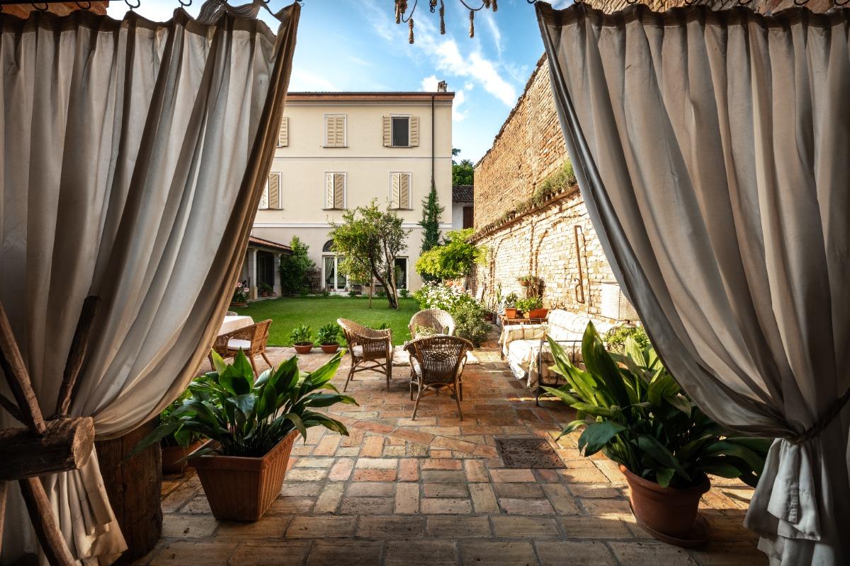 Entrance hall of the rustic house and inner courtyard with garden