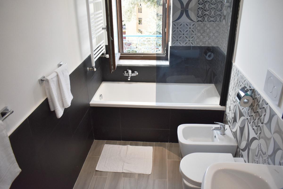 Bathroom with large window, bathtub, hair dryer, new