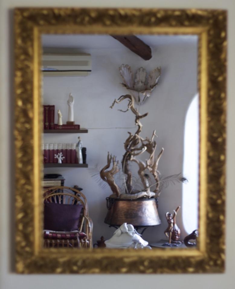 Mirror reflecting a part of the living room