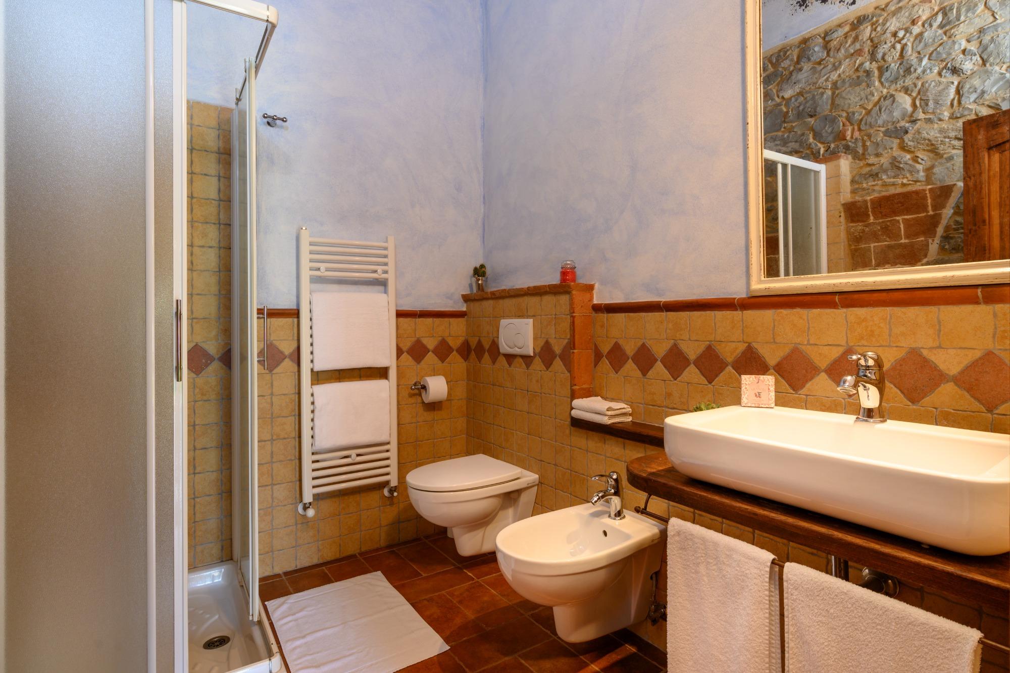 Bagno rustico con dettagli in legno e pietra