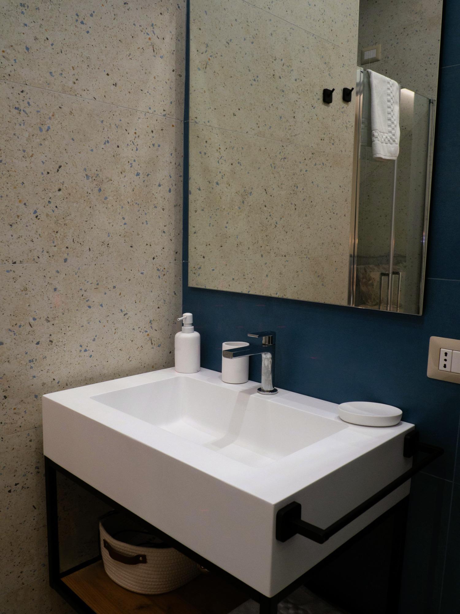 Detail of sink and mirror in Viaggio room bathroom