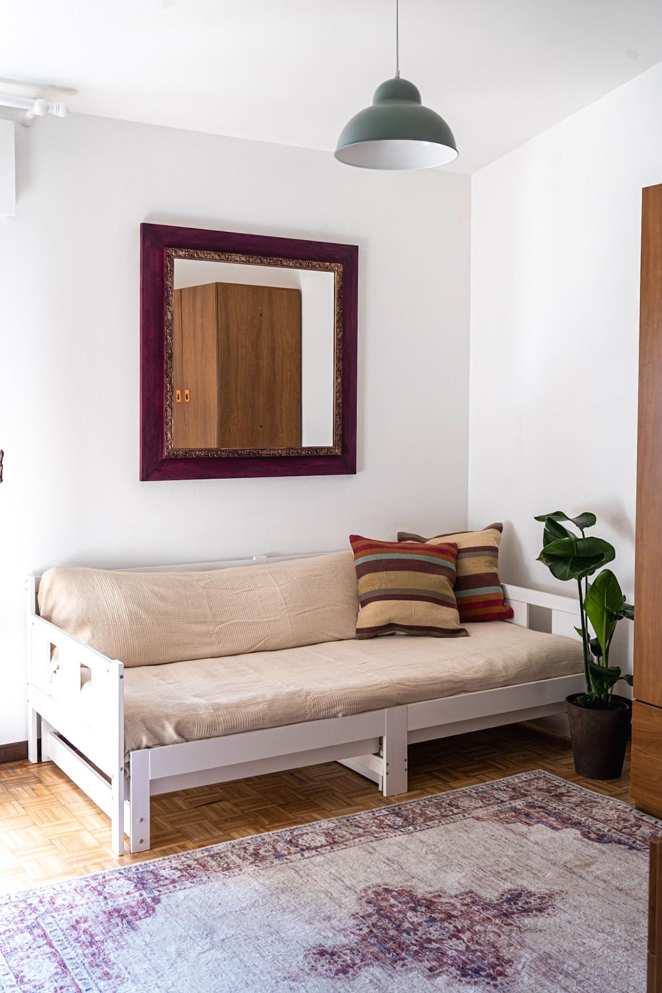 Camera guardaroba con un divano letto da 1 posto, completa con armadi, grucce, cassettiera